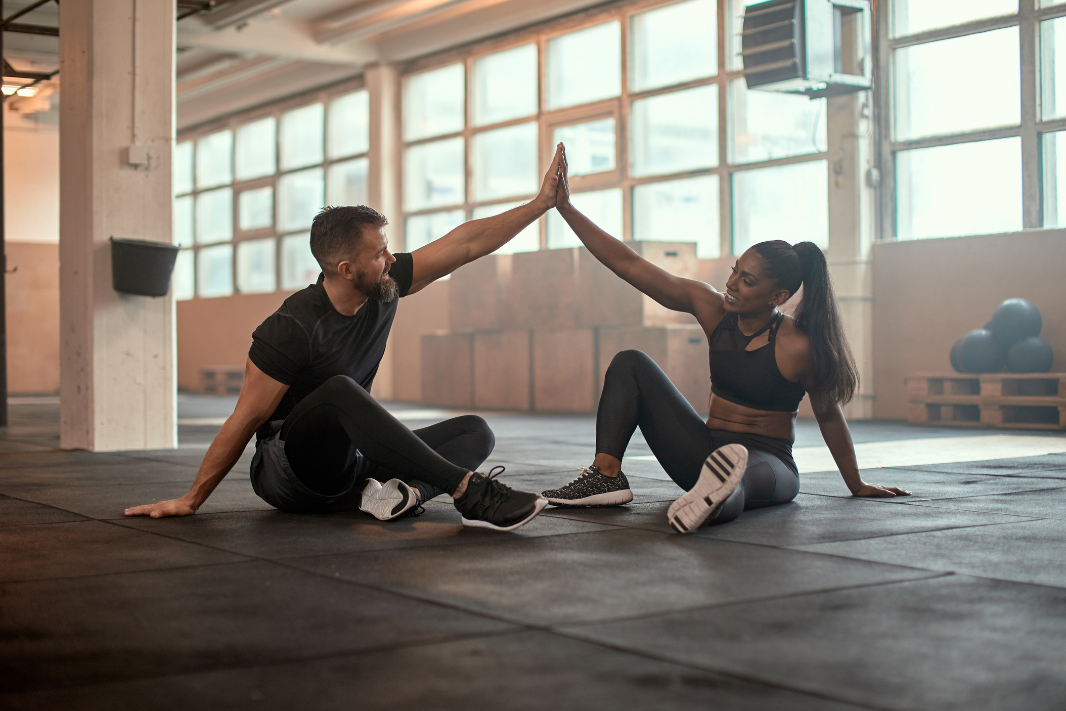 Workout Partners High-Fiving at the Gym